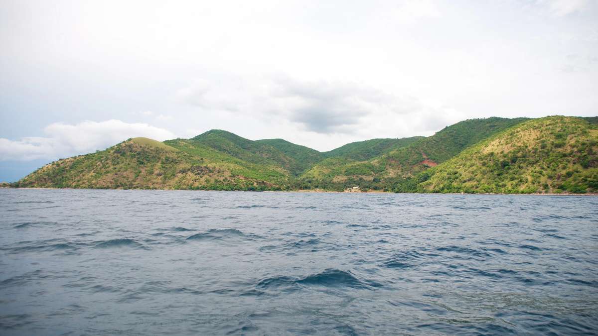 Rocky shoreline and clear blue water of Lake Tanganyika in East Africa